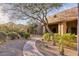 Landscaped walkway leading to a desert home, framed by natural vegetation, creating a serene and inviting entrance at 10067 E Santa Catalina Dr, Scottsdale, AZ 85255