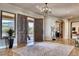 Elegant foyer featuring a decorative chandelier, marble floors, and a grand entrance at 10067 E Santa Catalina Dr, Scottsdale, AZ 85255