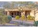 Inviting front entrance with desert landscaping and a charming pathway leading to the home at 10067 E Santa Catalina Dr, Scottsdale, AZ 85255