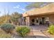 Inviting home exterior featuring a desert landscape and covered entrance with dark wood front door at 10067 E Santa Catalina Dr, Scottsdale, AZ 85255