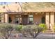 Charming front exterior with desert landscaping, a custom door, and a welcoming entrance at 10067 E Santa Catalina Dr, Scottsdale, AZ 85255