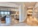 Expansive hallway connecting the living room with views to the kitchen with elegant lighting and scenic views at 10067 E Santa Catalina Dr, Scottsdale, AZ 85255