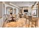 Elegant living room with fireplace, stylish furnishings, a breakfast bar, and contemporary lighting at 10067 E Santa Catalina Dr, Scottsdale, AZ 85255