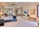 Large main bedroom with carpeted floors, recessed lights, large windows, and an open doorway to the main bathroom at 10067 E Santa Catalina Dr, Scottsdale, AZ 85255