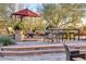 Inviting patio area with an umbrella, seating, and colorful flower arrangements, ideal for outdoor relaxation and entertainment at 10067 E Santa Catalina Dr, Scottsdale, AZ 85255