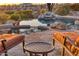 Backyard view of a custom pool and stone patio with desert scenery, ideal for outdoor gatherings at 10067 E Santa Catalina Dr, Scottsdale, AZ 85255