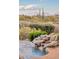 Attractive water feature with a small waterfall amidst desert landscaping at 10067 E Santa Catalina Dr, Scottsdale, AZ 85255