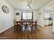 Dining room features wood floors and classic wooden table with seating for six at 10563 E Bramble Ave, Mesa, AZ 85208