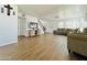 Open-concept living room with wood-look floors, neutral walls, and a comfortable sectional sofa at 10563 E Bramble Ave, Mesa, AZ 85208