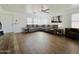 Spacious living room with a large sectional sofa, neutral walls, and wood-look floors at 10563 E Bramble Ave, Mesa, AZ 85208