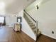 View of the home's carpeted staircase and landing, next to the entertainment center at 10563 E Bramble Ave, Mesa, AZ 85208