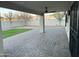 Inviting covered patio overlooking a spacious backyard with newly installed artificial turf and a paved area at 1102 W Burgess Ln, Phoenix, AZ 85041