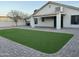 Well-maintained backyard featuring a covered patio area and newly installed artificial turf at 1102 W Burgess Ln, Phoenix, AZ 85041