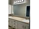 Well-lit bathroom showcasing a double sink vanity with granite countertops and updated fixtures at 1102 W Burgess Ln, Phoenix, AZ 85041