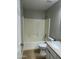 Clean bathroom featuring a shower-tub combo, tile floors, and white vanity with modern fixtures at 1102 W Burgess Ln, Phoenix, AZ 85041