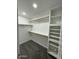 Organized walk-in closet with ample shelving and rods, providing storage solutions at 1102 W Burgess Ln, Phoenix, AZ 85041