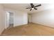 A well-lit bedroom with tile floors and a view to the bathroom at 11829 W Rosewood Dr, El Mirage, AZ 85335