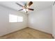 Bedroom with tile flooring, ceiling fan, and a window at 11829 W Rosewood Dr, El Mirage, AZ 85335