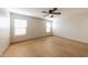 Bedroom featuring a ceiling fan, tile floor, and natural light at 11829 W Rosewood Dr, El Mirage, AZ 85335