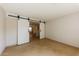 Bedroom featuring sliding doors and tile floors at 11829 W Rosewood Dr, El Mirage, AZ 85335