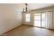 Cozy dining room with modern light fixture and access to a private backyard patio at 11829 W Rosewood Dr, El Mirage, AZ 85335