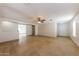 Open-concept living room with tile floors, white walls, and seamless flow to other areas at 11829 W Rosewood Dr, El Mirage, AZ 85335