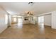 Expansive living room featuring neutral-toned walls, tile flooring, and abundant natural light at 11829 W Rosewood Dr, El Mirage, AZ 85335