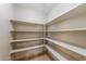 This is a walk-in pantry with multiple white shelves for storing food and cooking supplies at 11829 W Rosewood Dr, El Mirage, AZ 85335