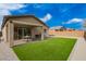 Backyard with covered patio, artificial turf, and privacy wall at 1211 E Jahns Dr, Casa Grande, AZ 85122