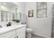 Bright bathroom with a single sink vanity, towel rack, butterfly art and garden accents at 1211 E Jahns Dr, Casa Grande, AZ 85122