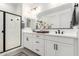 Modern bathroom with dual sinks, white cabinets, and a glass-enclosed shower at 1211 E Jahns Dr, Casa Grande, AZ 85122