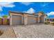 A well-maintained single-Gathering house with a three-car garage and low-maintenance desert landscaping at 1211 E Jahns Dr, Casa Grande, AZ 85122