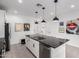 Kitchen island features a sink with white cabinetry and hardware, and stainless steel appliances at 1211 E Jahns Dr, Casa Grande, AZ 85122