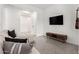 Modern living room featuring tile floors, a wall-mounted television and a cozy sectional sofa at 1211 E Jahns Dr, Casa Grande, AZ 85122