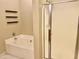 Bathroom featuring a soaking tub, shower, and white tile, perfect for relaxation at 1225 N 36Th St # 1054, Phoenix, AZ 85008