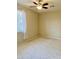 A standard bedroom with neutral carpet, ceiling fan and light neutral paint at 1225 N 36Th St # 1054, Phoenix, AZ 85008