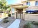 Inviting front entrance with a secure gated patio, covered porch, and desert landscaping at 1225 N 36Th St # 1054, Phoenix, AZ 85008