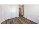 Bedroom featuring luxury vinyl plank flooring, closet with sliding doors, and white trim at 12325 W Charter Oak Rd, El Mirage, AZ 85335