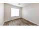 Cozy bedroom featuring luxury vinyl plank flooring and natural light from a window at 12325 W Charter Oak Rd, El Mirage, AZ 85335