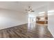 Spacious living room featuring modern wood floors, ceiling fan, and plenty of natural light at 12325 W Charter Oak Rd, El Mirage, AZ 85335