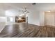 Bright and airy living room with wood floors flows into the kitchen for easy entertaining at 12325 W Charter Oak Rd, El Mirage, AZ 85335