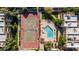 Aerial shot of tennis court and inviting community pool, surrounded by lush greenery and seating at 1328 S Mckemy St, Tempe, AZ 85281