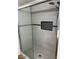 Updated shower with gray tile surround and black tile niche at 1328 S Mckemy St, Tempe, AZ 85281