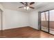 Bright bedroom with hardwood floors and a sliding glass door leading to a balcony at 1328 S Mckemy St, Tempe, AZ 85281