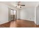 Light-filled bedroom features hardwood floors, ceiling fan, and access to outdoor balcony at 1328 S Mckemy St, Tempe, AZ 85281