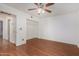 Bedroom with hardwood floors, ceiling fan, closet and passage to the bathroom at 1328 S Mckemy St, Tempe, AZ 85281