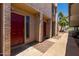 Townhouse exterior showcasing red front doors, well-kept landscaping, and stucco facade at 1328 S Mckemy St, Tempe, AZ 85281