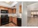 Well-lit kitchen featuring stainless steel appliances, tile flooring, and an open view to the living area at 1328 S Mckemy St, Tempe, AZ 85281