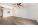 Open living space with modern flooring, a ceiling fan, and an open view to the kitchen at 1328 S Mckemy St, Tempe, AZ 85281