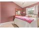 Cozy bedroom with plush bedding, a dresser, and a window allowing natural light into the room at 1333 E Rockledge Rd, Phoenix, AZ 85048